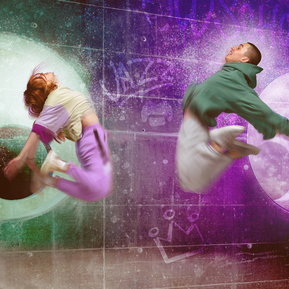 Two people in mid-air, each surrounded by a glowing circular shape, one green and one purple, with abstract background elements.