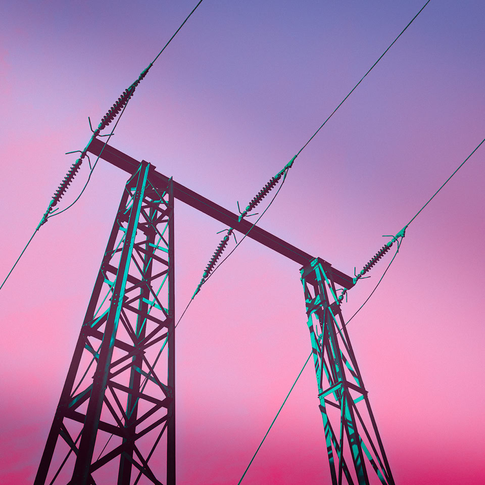 Transmission tower with power lines against a pink and purple sky.